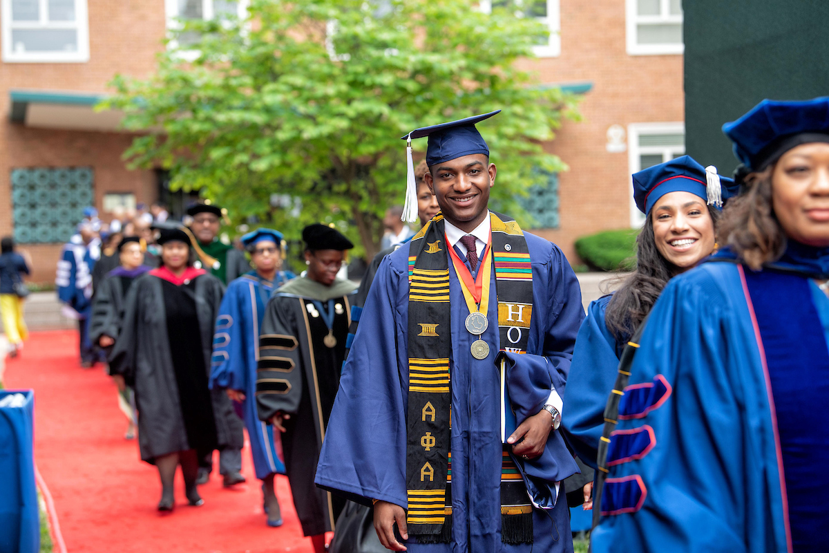 Candid shot of student walking to seat during commencement