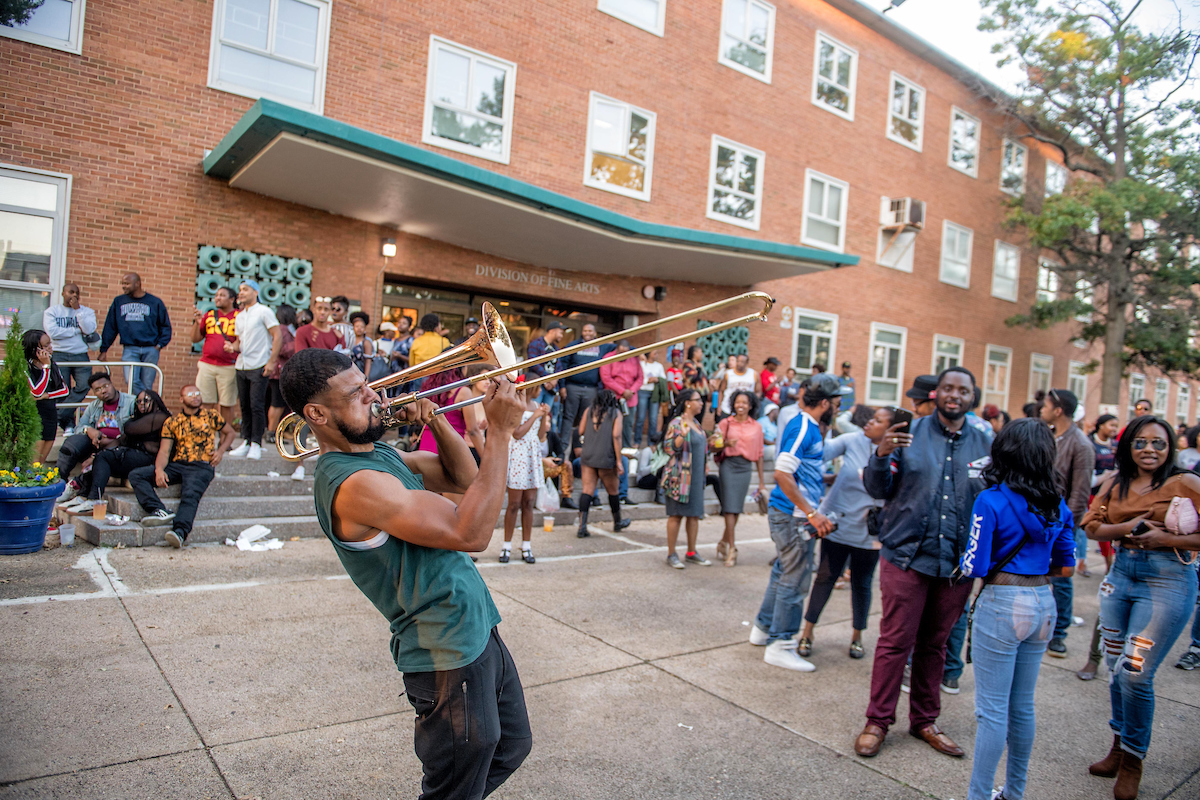 Student Playing Instrument outside Division of Fine Arts