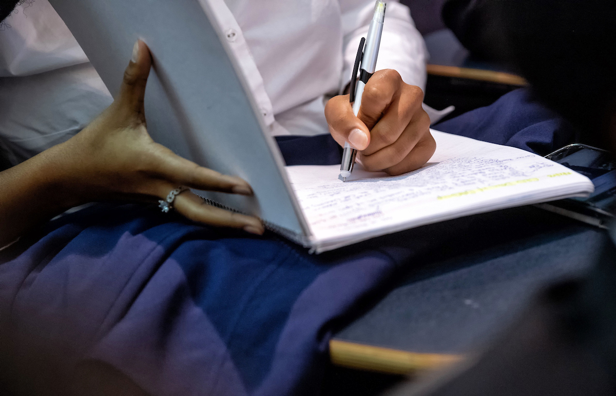 Student taking notes in notebook