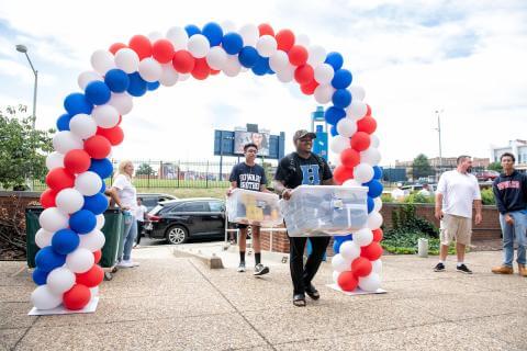 Male student moving into campus dorm