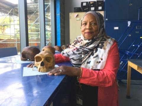 Dr. Fatimah Jackson with skeleton skulls in Cobb Research Lab