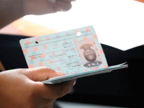 Hand holding an official passport