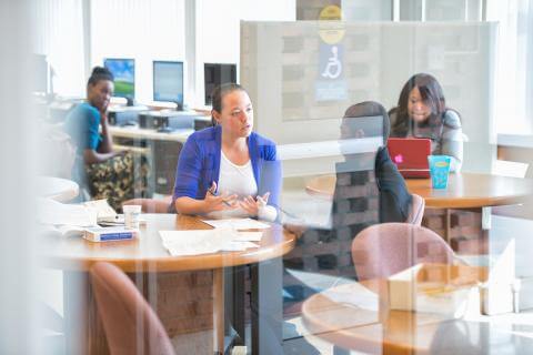 View through glass doors of stakeholders talking