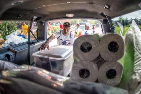 Young man unloading luggage to move into student dorms