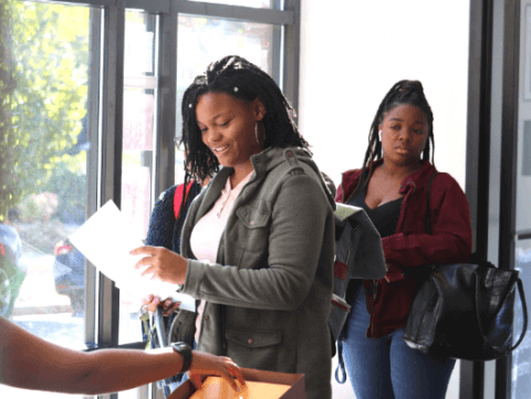Students gather in Bunche Center to submit passport applications and take photos