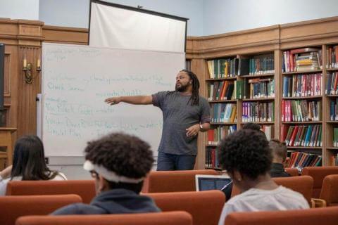 students listening to professor in classroom